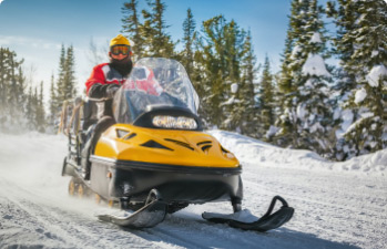 Happy snowmobile borrower enjoying his vehicle financed with a snowmobile loan